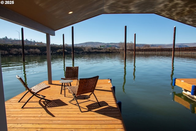 view of dock featuring a water and mountain view