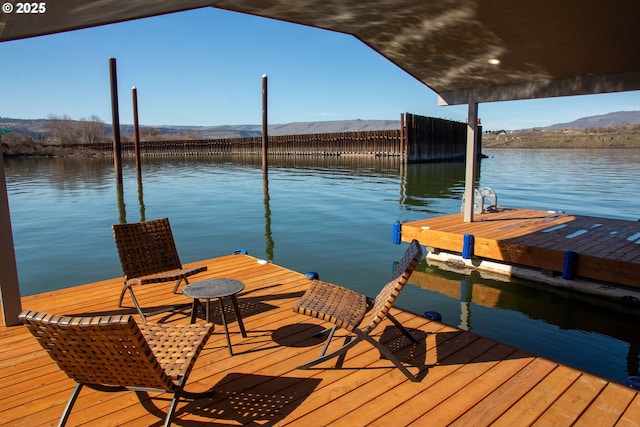 view of dock featuring a water and mountain view