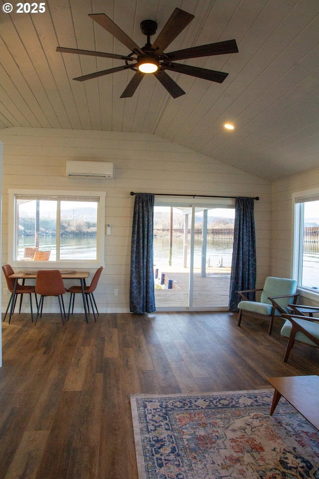 interior space featuring lofted ceiling, wooden ceiling, wood finished floors, a ceiling fan, and a wall mounted AC