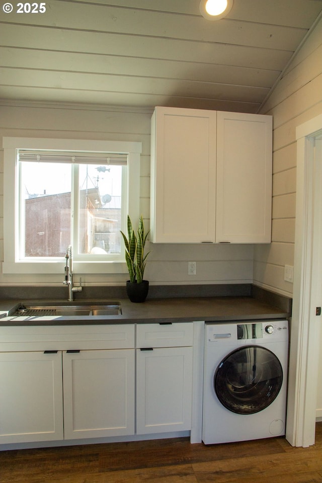 washroom with a sink, wood ceiling, cabinet space, washer / clothes dryer, and dark wood finished floors