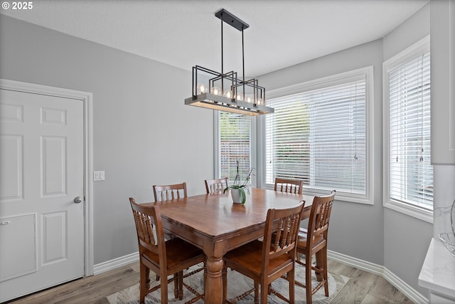 16436 Visionary Ct, Oregon City, OR 97045 - dining area featuring light wood-type flooring, baseboards, and a chandelier