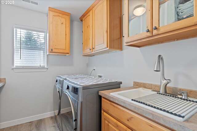 16436 Visionary Ct, Oregon City, OR 97045 - laundry area featuring washer and clothes dryer, cabinet space, baseboards, and wood finished floors