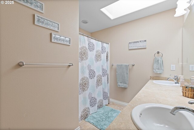 16436 Visionary Ct, Oregon City, OR 97045 - bathroom with double vanity, a skylight, curtained shower, and baseboards