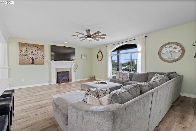 16436 Visionary Ct, Oregon City, OR 97045 - living room with ceiling fan, wood finished floors, a tile fireplace, and baseboards