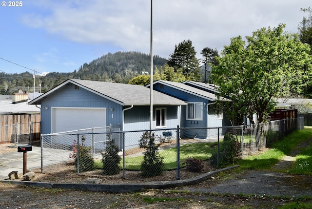 29519 Crook St, Gold Beach, OR 97444 - view of front facade with concrete driveway, a mountain view, an attached garage, and a fenced front yard