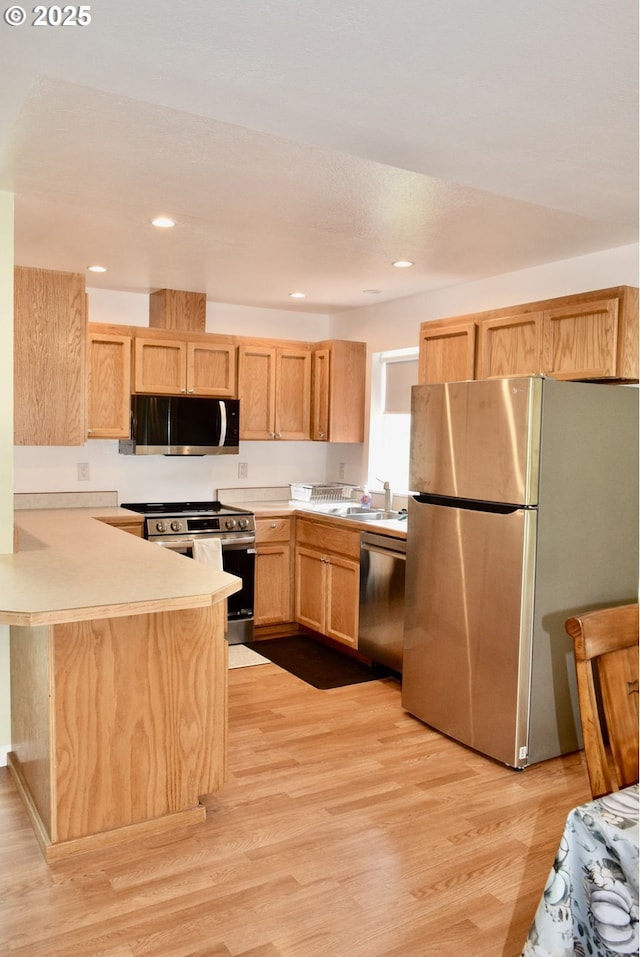 29519 Crook St, Gold Beach, OR 97444 - kitchen with light countertops, appliances with stainless steel finishes, a peninsula, and light brown cabinets
