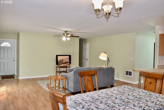 29519 Crook St, Gold Beach, OR 97444 - dining space with wood finished floors, ceiling fan with notable chandelier, baseboards, and visible vents