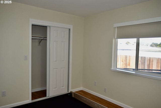 29519 Crook St, Gold Beach, OR 97444 - unfurnished bedroom with dark wood-type flooring, a closet, and baseboards