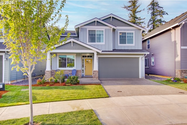 craftsman inspired home with board and batten siding, covered porch, driveway, a front yard, and an attached garage