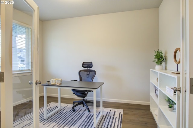 home office featuring baseboards and wood finished floors
