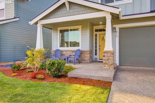 entrance to property featuring covered porch, board and batten siding, concrete driveway, and stone siding