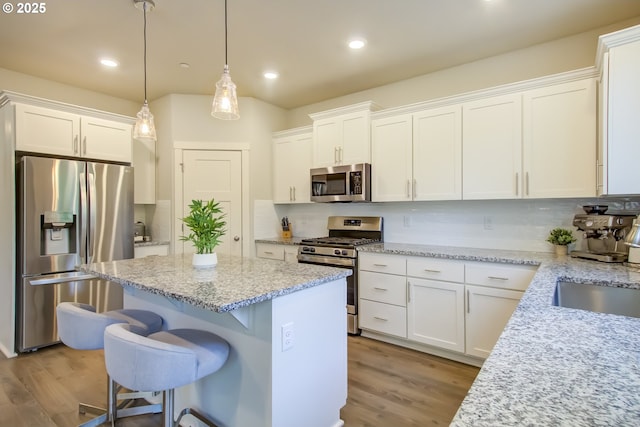 kitchen with a center island, white cabinetry, and stainless steel appliances