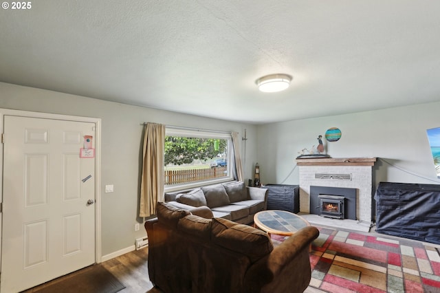 living room featuring a baseboard radiator, dark hardwood / wood-style floors, and a textured ceiling