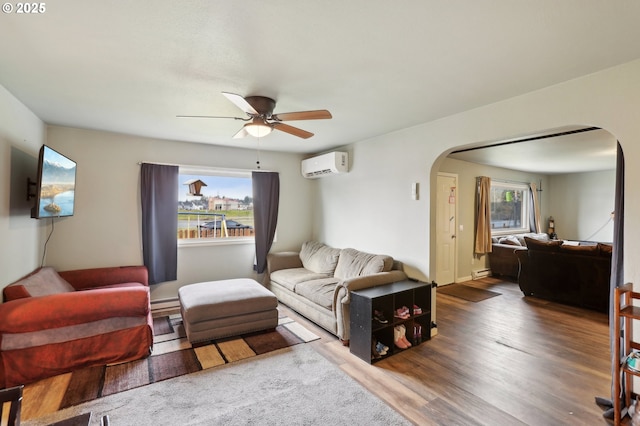 living room with a baseboard radiator, dark hardwood / wood-style floors, a wall mounted AC, and ceiling fan