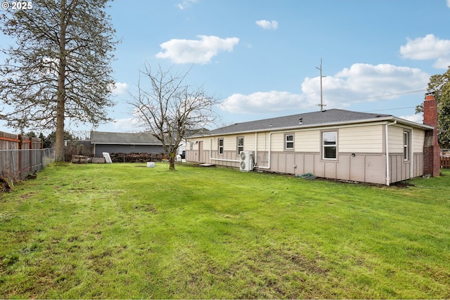 rear view of property with a yard