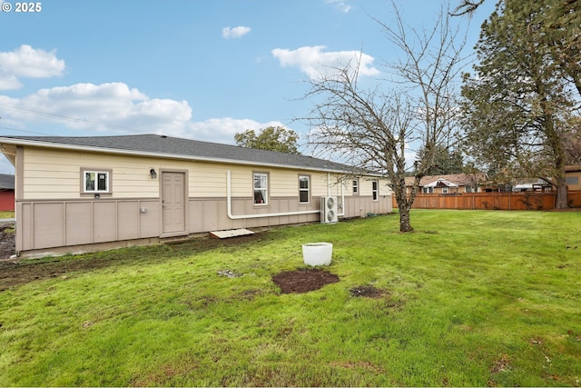 back of property with a lawn