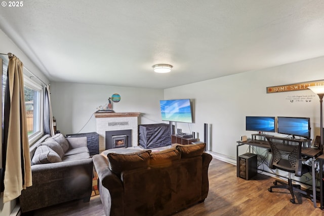 324 N 18th St, Saint Helens, OR 97051 - living area featuring wood finished floors, a warm lit fireplace, and a desk