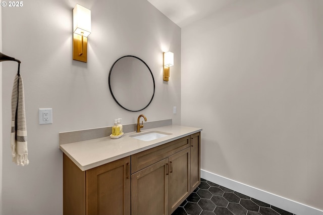 bathroom featuring tile patterned floors, baseboards, and vanity