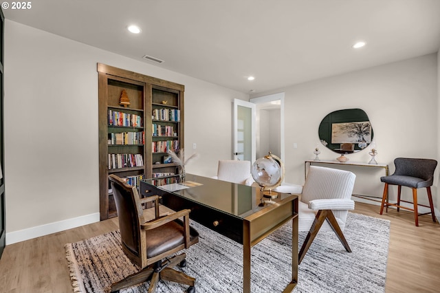 office with light wood-type flooring, baseboards, visible vents, and recessed lighting
