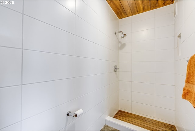 bathroom featuring wooden ceiling and a tile shower