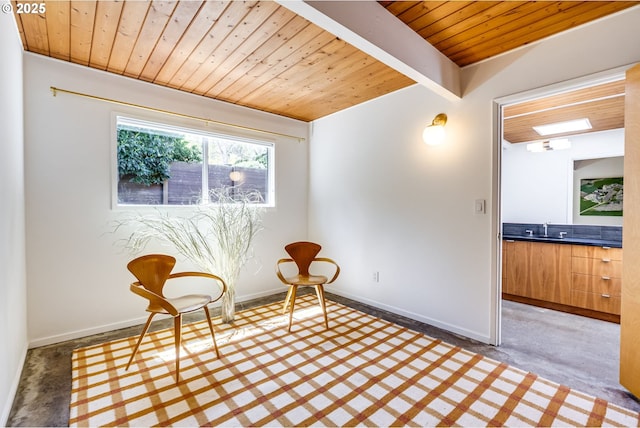 living area featuring wood ceiling and baseboards