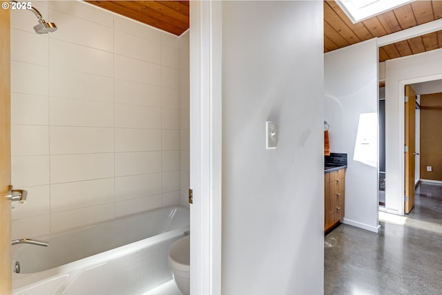 bathroom with a skylight, wooden ceiling, vanity, and concrete floors