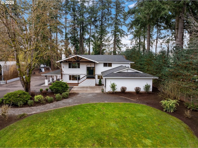 view of front of home featuring driveway, a shingled roof, a patio, a chimney, and a front yard