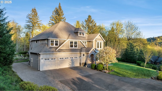 view of front of home with a garage and a front lawn