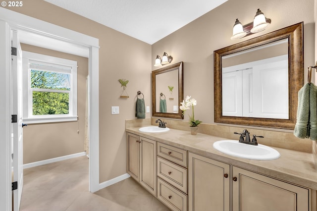 bathroom with tile patterned floors and vanity