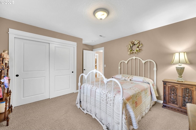 carpeted bedroom featuring a closet