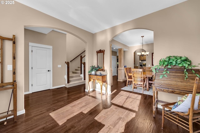 foyer entrance featuring hardwood / wood-style floors and an inviting chandelier