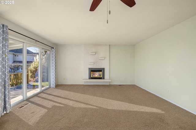 unfurnished living room featuring carpet floors and a large fireplace