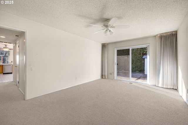 carpeted empty room featuring a textured ceiling and ceiling fan