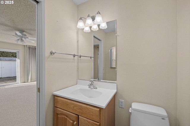 bathroom with ceiling fan, vanity, and toilet