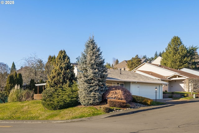 view of front of house featuring a garage and a front lawn