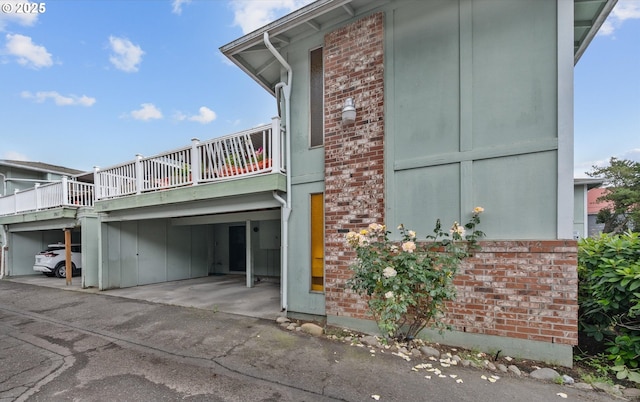 12841 SE Stark St Unit A19, Portland, OR 97233 - view of home's exterior featuring brick siding and covered parking