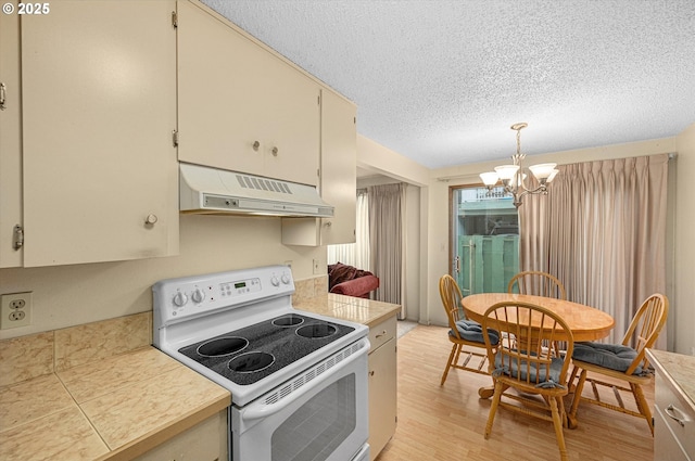12841 SE Stark St Unit A19, Portland, OR 97233 - kitchen featuring white electric range, range hood, a chandelier, a textured ceiling, and light wood finished floors