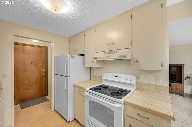 12841 SE Stark St Unit A19, Portland, OR 97233 - kitchen featuring white appliances, ventilation hood, cream cabinets, a textured ceiling, and tile countertops
