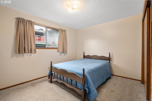 12841 SE Stark St Unit A19, Portland, OR 97233 - bedroom featuring light colored carpet, baseboards, and a textured ceiling
