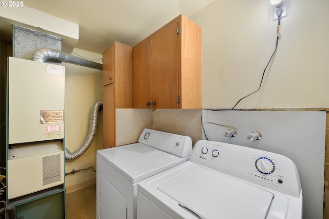 12841 SE Stark St Unit A19, Portland, OR 97233 - laundry room featuring washer and clothes dryer, cabinet space, and heating unit