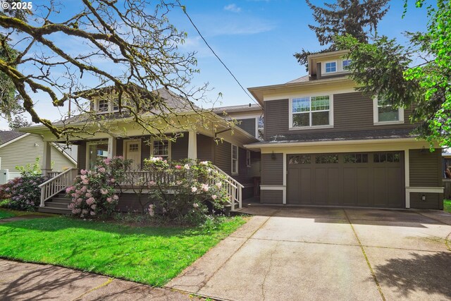 view of front of home featuring a porch, a garage, a front yard, and concrete driveway