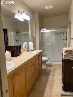 bathroom with walk in shower, vanity, and toilet