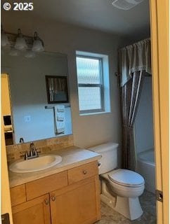 full bathroom with vanity, shower / bath combo, and toilet