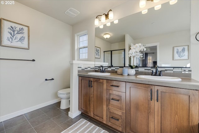 bathroom with vanity, toilet, tile patterned flooring, and decorative backsplash