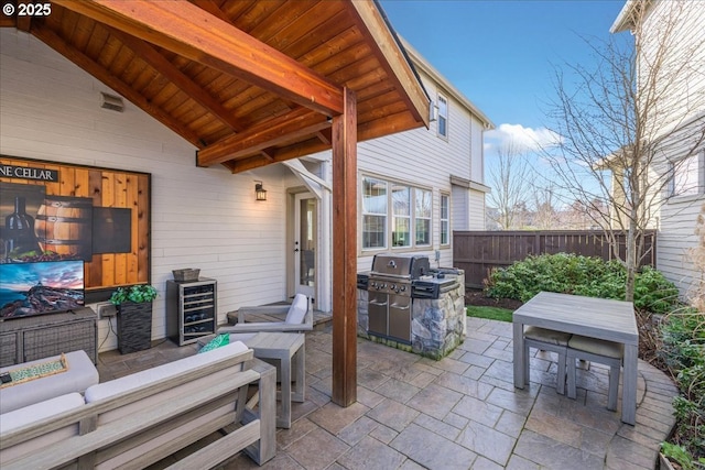 view of patio with outdoor lounge area, a grill, and wine cooler