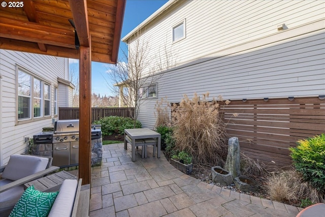 view of patio with an outdoor kitchen and a grill