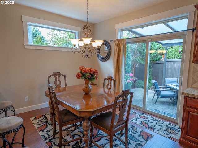 14988 SE Glenbrook Rd, Clackamas, OR 97015 - dining space with healthy amount of natural light, a chandelier, and wood finished floors