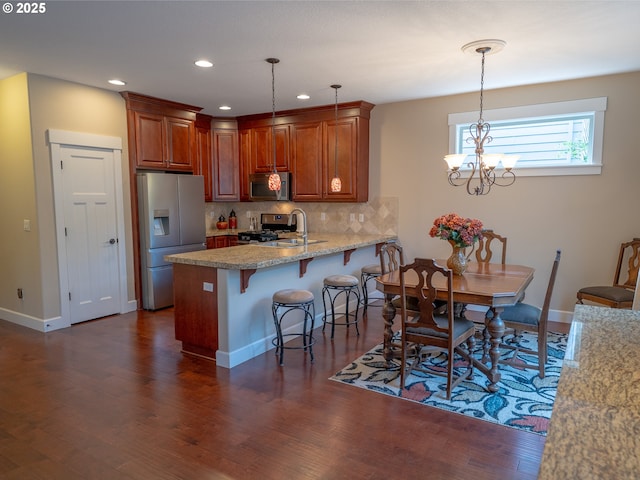 14988 SE Glenbrook Rd, Clackamas, OR 97015 - kitchen with appliances with stainless steel finishes, a peninsula, decorative backsplash, dark wood finished floors, and recessed lighting