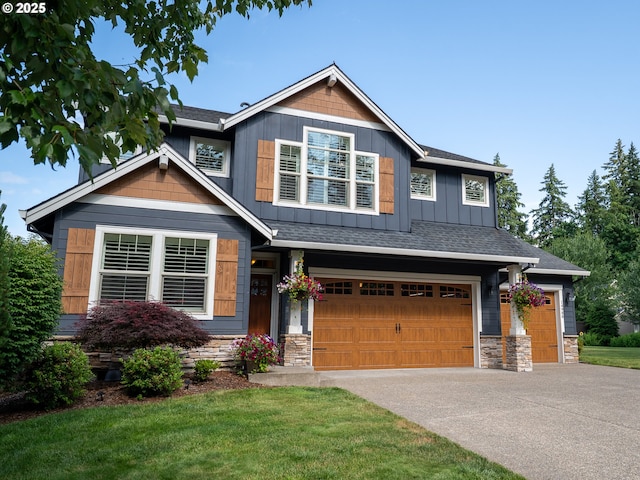 14988 SE Glenbrook Rd, Clackamas, OR 97015 - craftsman-style house featuring a garage, stone siding, driveway, and a front yard