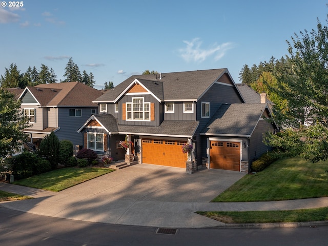 14988 SE Glenbrook Rd, Clackamas, OR 97015 - craftsman-style house with board and batten siding, driveway, a garage, stone siding, and a front lawn